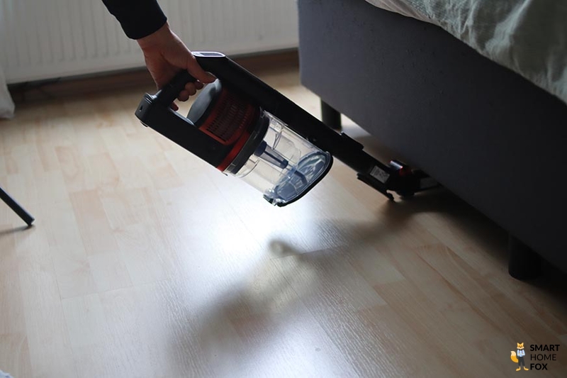 Shark Anti Hair Wrap Flexoloxy is seen cleaning under furniture.
